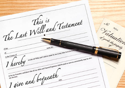 Last will and testament A will and testament document with a pen resting on it.